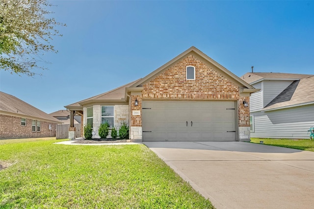 view of front of house with an attached garage, concrete driveway, a front lawn, stone siding, and brick siding