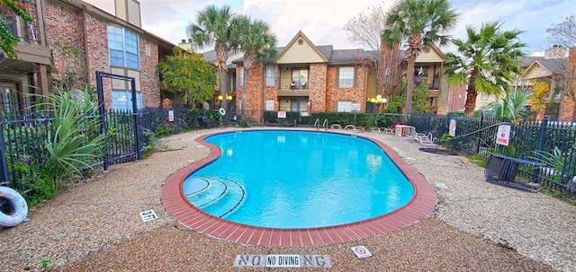 community pool featuring fence