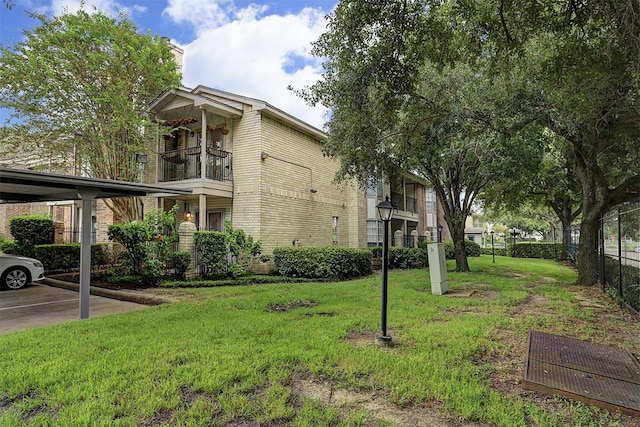 exterior space featuring a balcony and fence