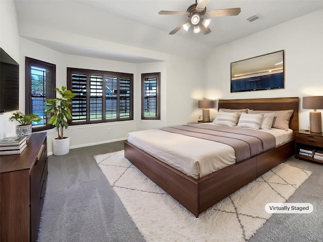 carpeted bedroom with visible vents, baseboards, ceiling fan, and vaulted ceiling