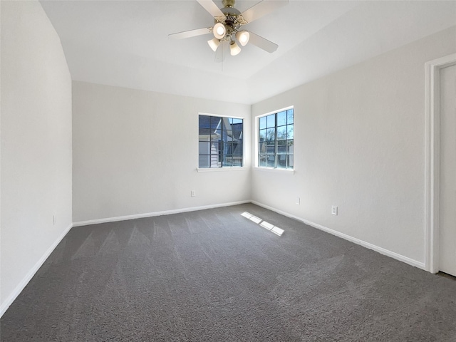 empty room with dark carpet, baseboards, and ceiling fan