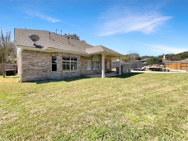 back of house with a patio, a fenced backyard, central air condition unit, a lawn, and brick siding