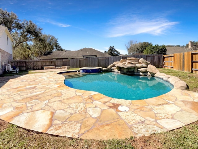 view of swimming pool with a patio area, a pool with connected hot tub, and a fenced backyard