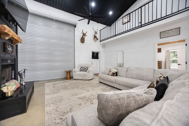 living room featuring ceiling fan, recessed lighting, a fireplace, and high vaulted ceiling