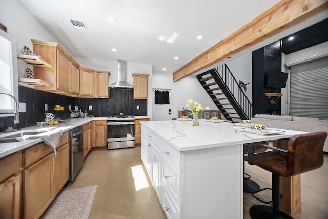 kitchen with a kitchen island, wall chimney range hood, decorative backsplash, stainless steel appliances, and open shelves