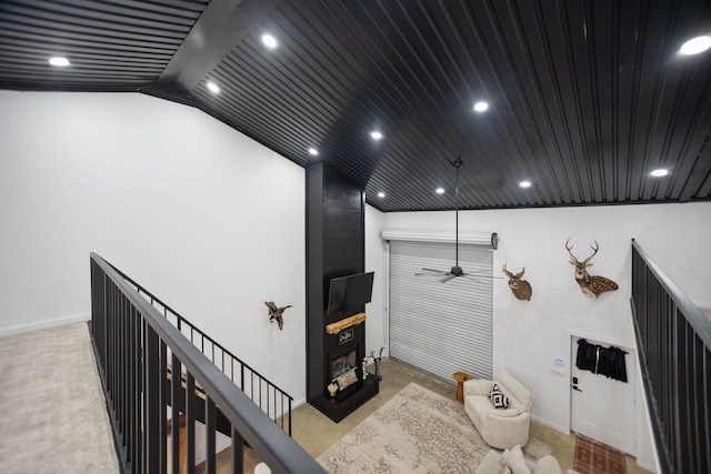 interior space featuring recessed lighting, an upstairs landing, and a fireplace