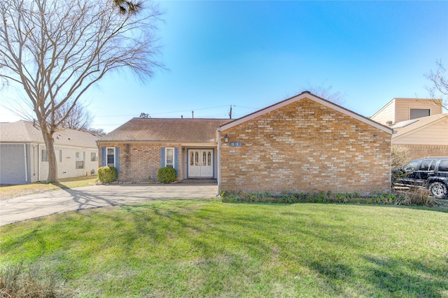 ranch-style house with a front lawn, brick siding, and a shingled roof