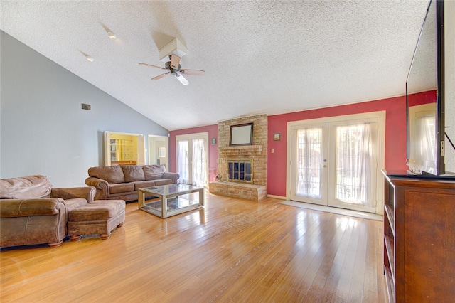 living room featuring french doors, light wood-style floors, a healthy amount of sunlight, and ceiling fan