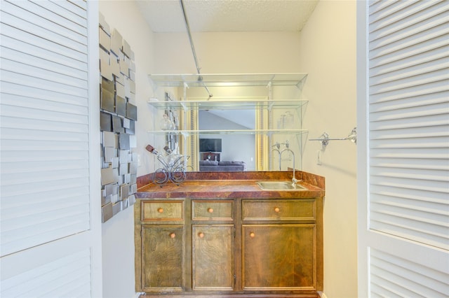 bathroom featuring vanity and a textured ceiling