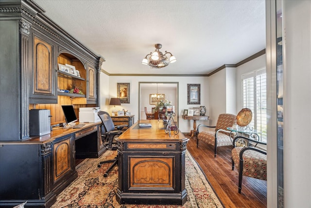 office space featuring a chandelier, dark wood-style floors, a textured ceiling, and ornamental molding