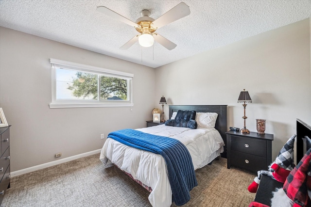 carpeted bedroom featuring a ceiling fan, baseboards, and a textured ceiling