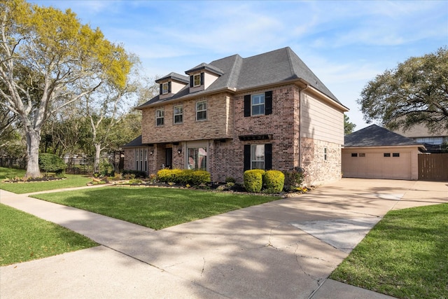 view of front of house with driveway, fence, a front yard, a garage, and brick siding