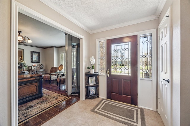 foyer featuring wood finished floors, a textured ceiling, and ornamental molding