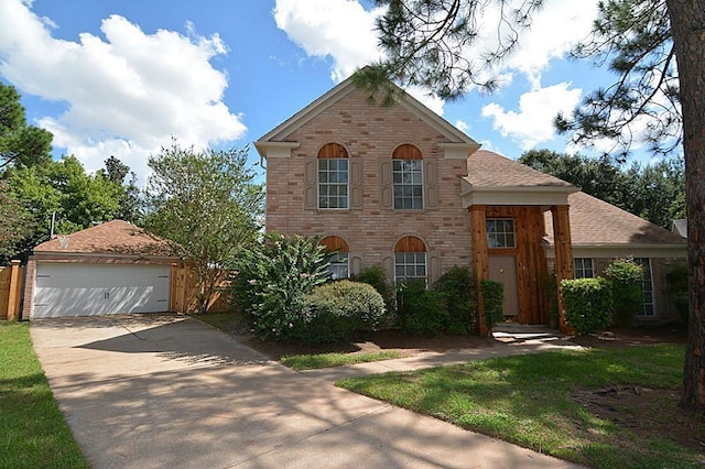 traditional-style home with a garage, brick siding, roof with shingles, and driveway