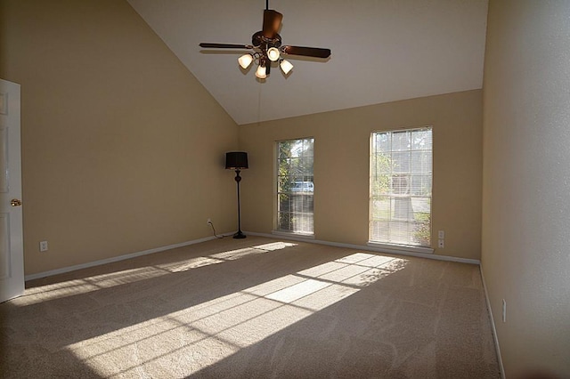 spare room featuring carpet flooring, a ceiling fan, baseboards, and high vaulted ceiling