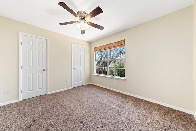 unfurnished bedroom featuring baseboards, carpet floors, and a ceiling fan