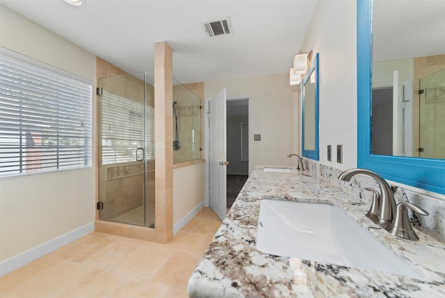 bathroom featuring a sink, visible vents, a shower stall, and tile patterned floors