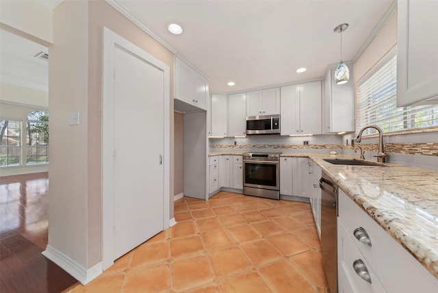 kitchen featuring a sink, decorative backsplash, plenty of natural light, and stainless steel appliances