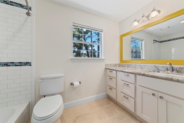 bathroom featuring tile patterned floors, toilet, vanity, baseboards, and shower / bathtub combination