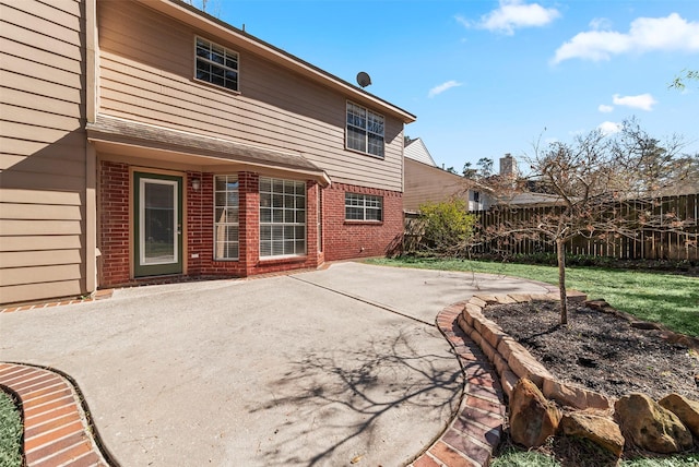 back of house with a patio area, brick siding, and fence