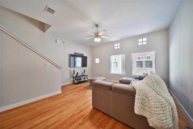 8705 Bryam St Unit 1605, Houston, TX 77061 - living room featuring a ceiling fan, light wood finished floors, and baseboards