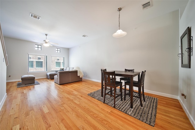 8705 Bryam St Unit 1605, Houston, TX 77061 - dining room with light wood-type flooring, a ceiling fan, and baseboards