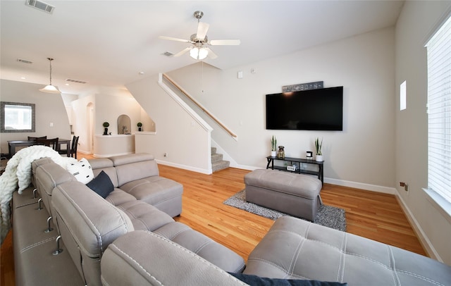8705 Bryam St Unit 1605, Houston, TX 77061 - living area featuring stairway, wood finished floors, ceiling fan, and plenty of natural light