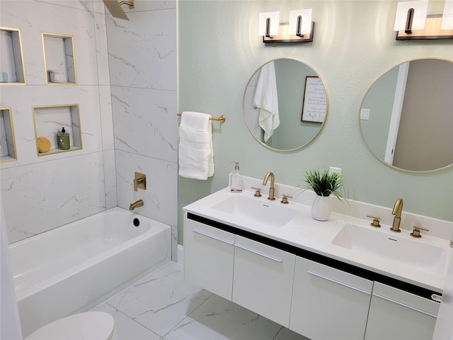 full bath with double vanity, marble finish floor, shower / bathtub combination, and a sink