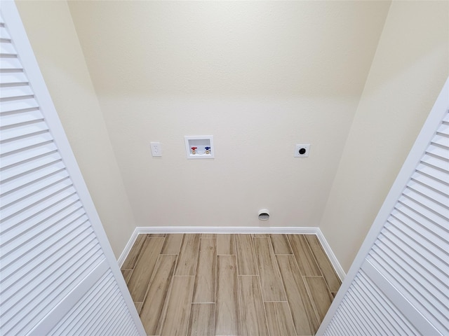 laundry room with baseboards, washer hookup, laundry area, wood finished floors, and hookup for an electric dryer