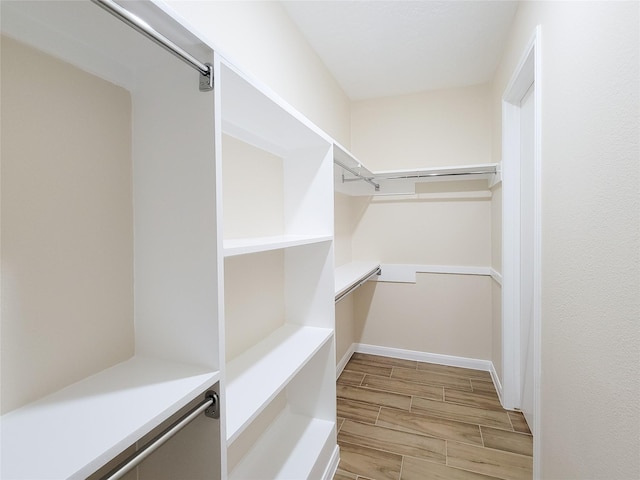 walk in closet featuring wood finish floors