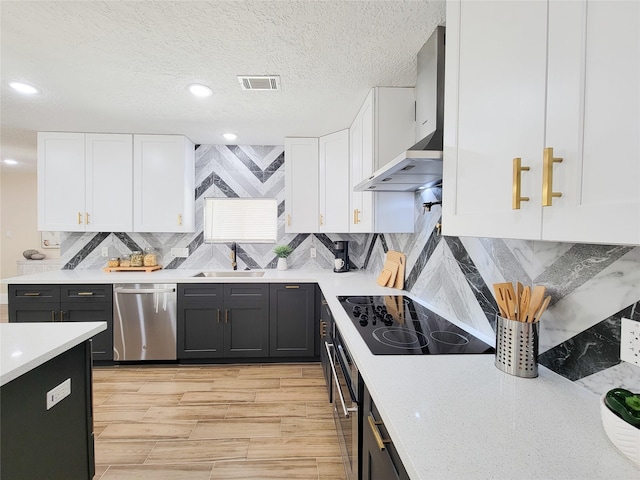 kitchen with visible vents, light countertops, stainless steel appliances, white cabinetry, and a sink