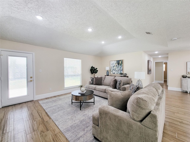 living room with recessed lighting, light wood-style floors, visible vents, and baseboards