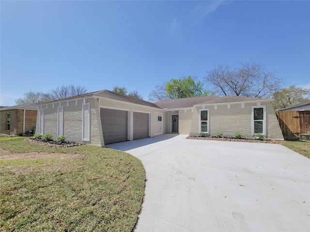 view of front of home with concrete driveway, brick siding, a garage, and a front yard