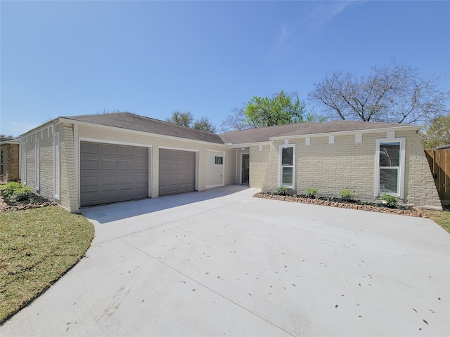 view of front of property with brick siding, concrete driveway, and an attached garage