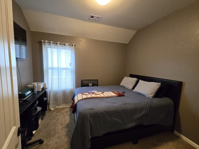 bedroom featuring visible vents, carpet floors, baseboards, and vaulted ceiling