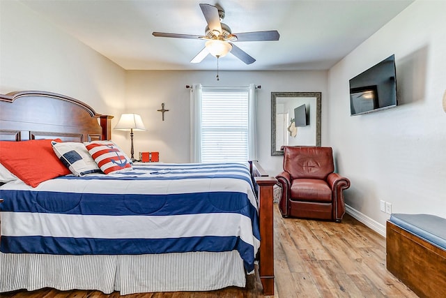 bedroom featuring wood finished floors, baseboards, and ceiling fan