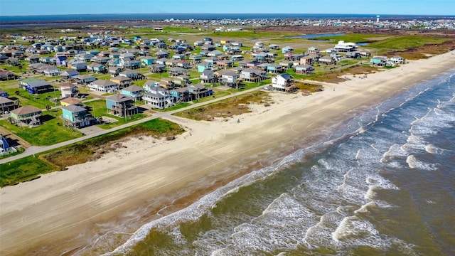 aerial view with a residential view, a water view, and a beach view