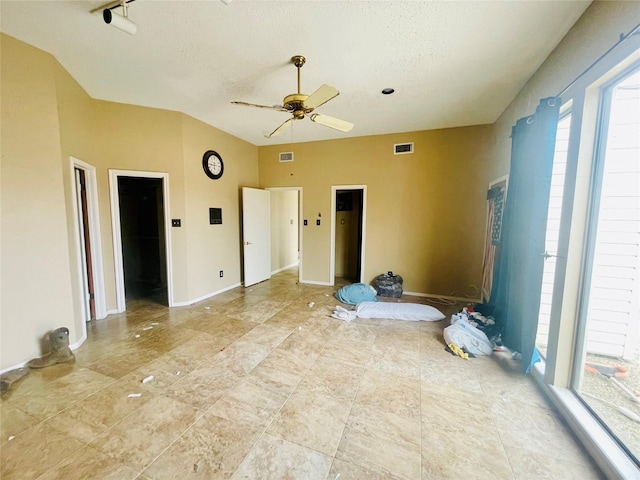 bedroom with visible vents, baseboards, a textured ceiling, and ceiling fan