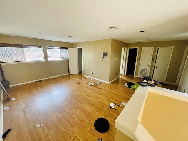 interior space with light wood-style flooring, baseboards, and visible vents