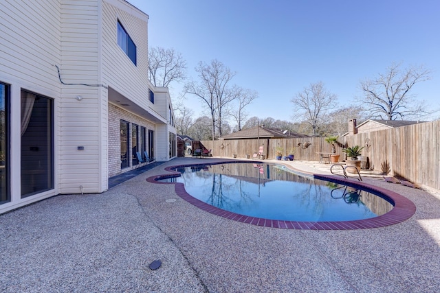 view of pool featuring a patio area, a fenced in pool, and a fenced backyard