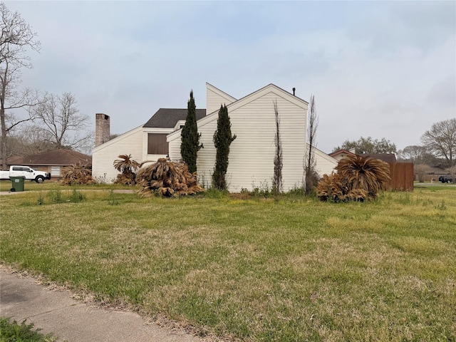 view of side of property with a lawn