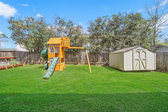 view of play area with an outbuilding, a lawn, a storage shed, and a fenced backyard