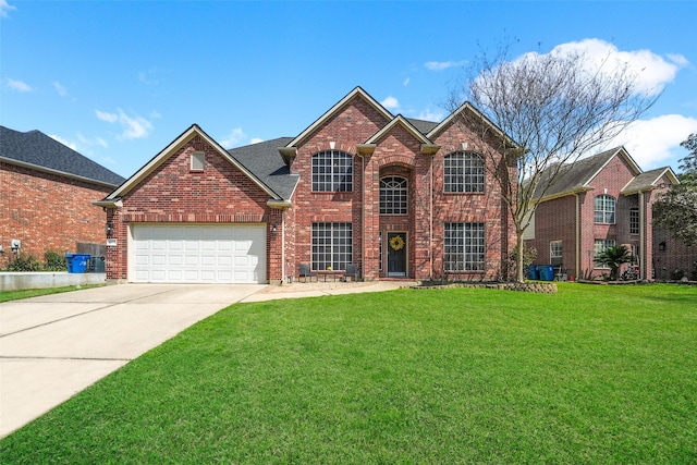 traditional home with a front yard, an attached garage, brick siding, and driveway