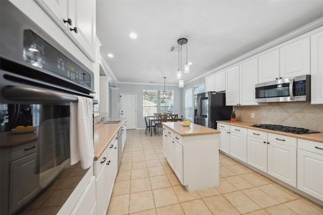 kitchen featuring backsplash, appliances with stainless steel finishes, crown molding, and white cabinetry