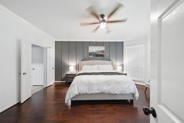 bedroom featuring baseboards, wood-type flooring, and ornamental molding