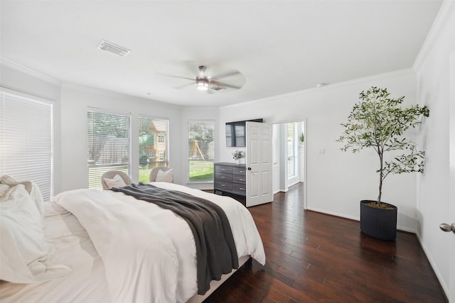 bedroom featuring visible vents, baseboards, dark wood-type flooring, and ornamental molding