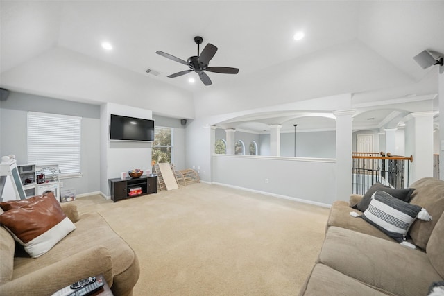 carpeted living room featuring vaulted ceiling, visible vents, ceiling fan, and decorative columns