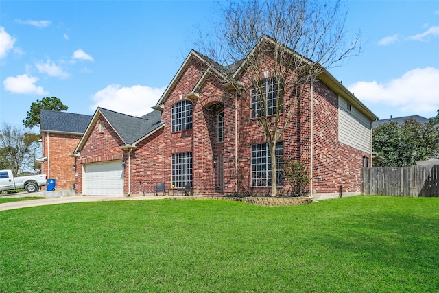 traditional-style house featuring a front yard, fence, driveway, a garage, and brick siding