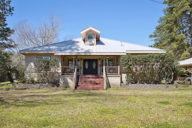 bungalow-style home featuring a porch, a front lawn, and metal roof