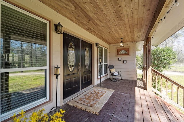 view of exterior entry with a porch